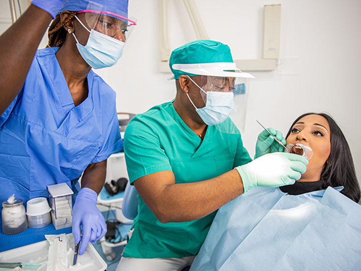 Home 6 a dentist checks a patient s teeth in an african d 2025 03 09 11 49 38 utc