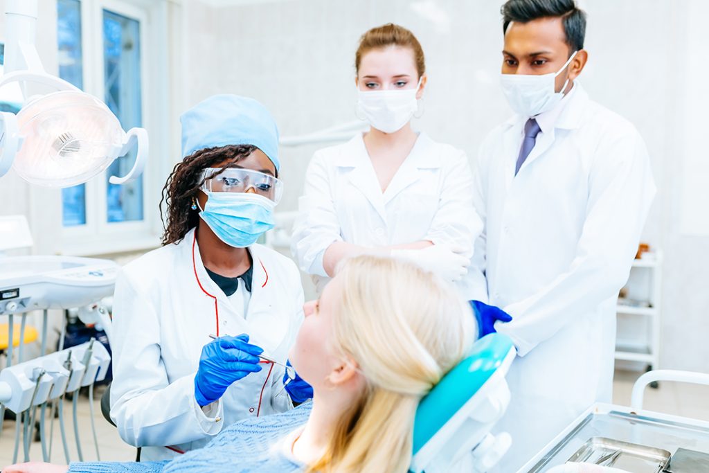 multiracial dental team with patient in dental cli 2025 01 29 04 39 50 utc