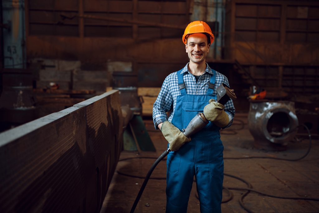 Industries We Serve 2 worker in helmet works with metal workpieces 2024 12 04 06 44 36 utc